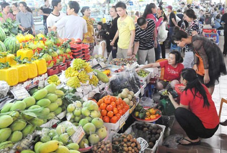 Consumers buy fruits at a market in HCMC (Photo: SGGP)